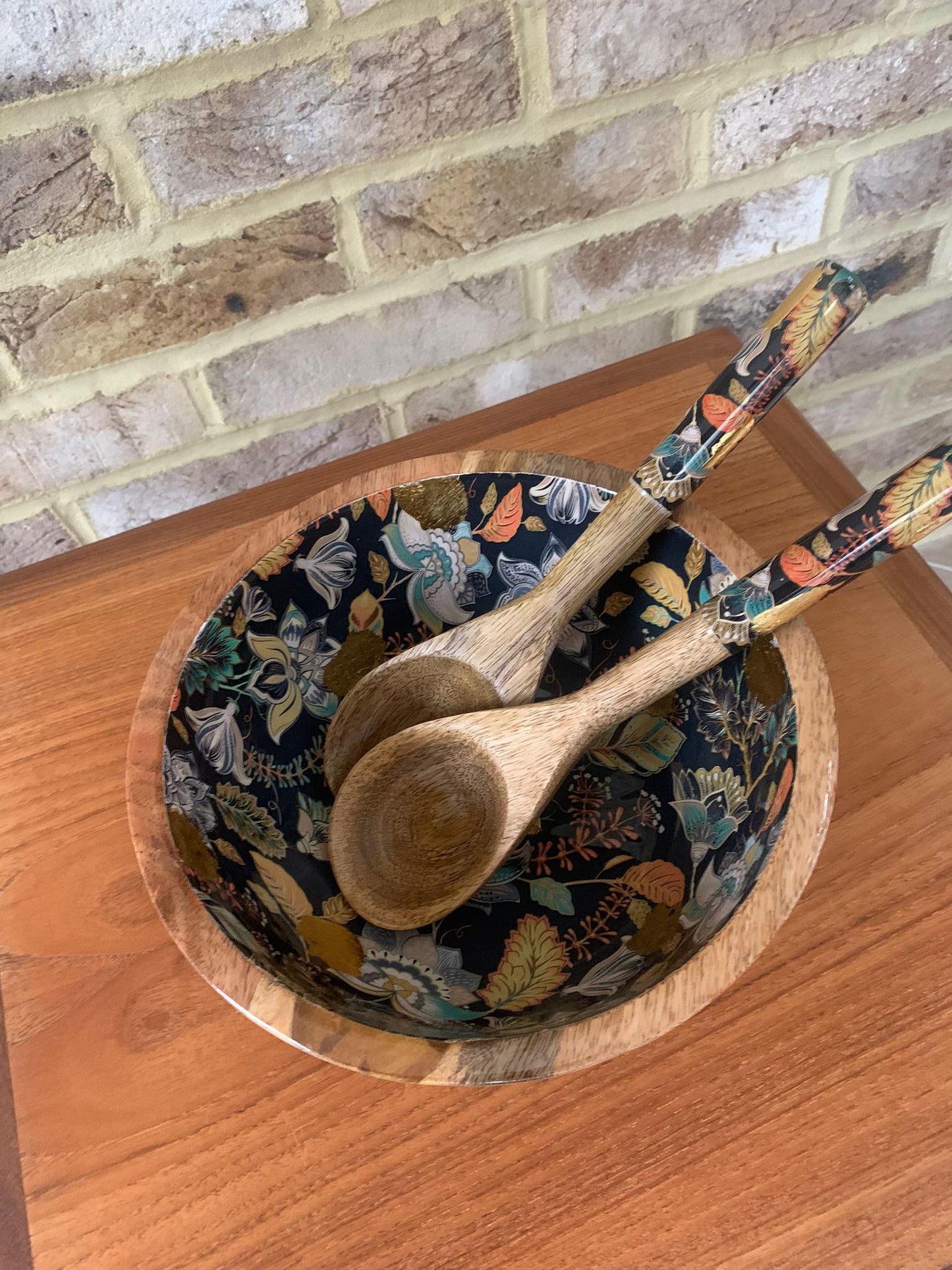 Medium bowl with matching salad servers.  Elegant floral design against a black background featuring stunning accents of gold foil.